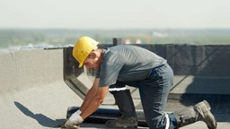 professional undertaking roof waterproofing on residential building